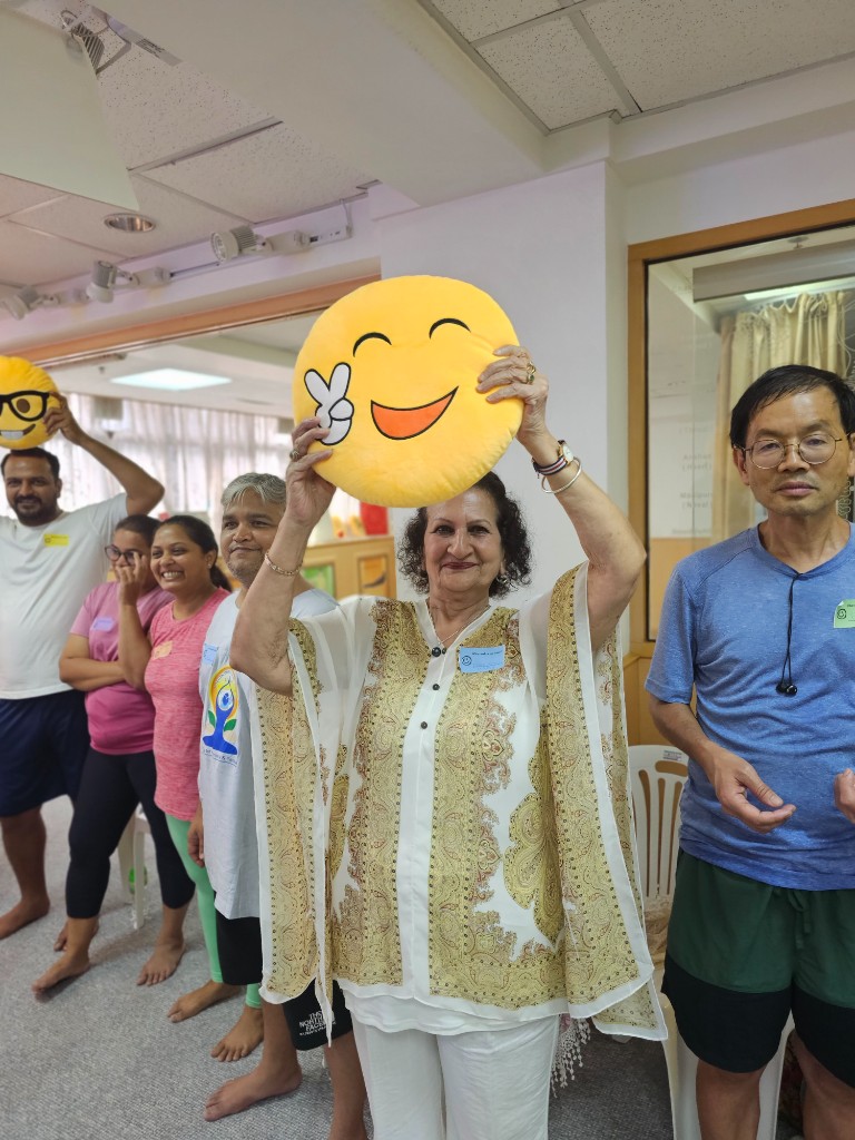SMILE Ambassador trainees holding emoji cushions at LMYC